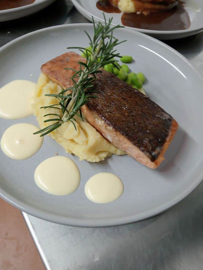 Crispy-skin salmon on mash with peas and hollandaise